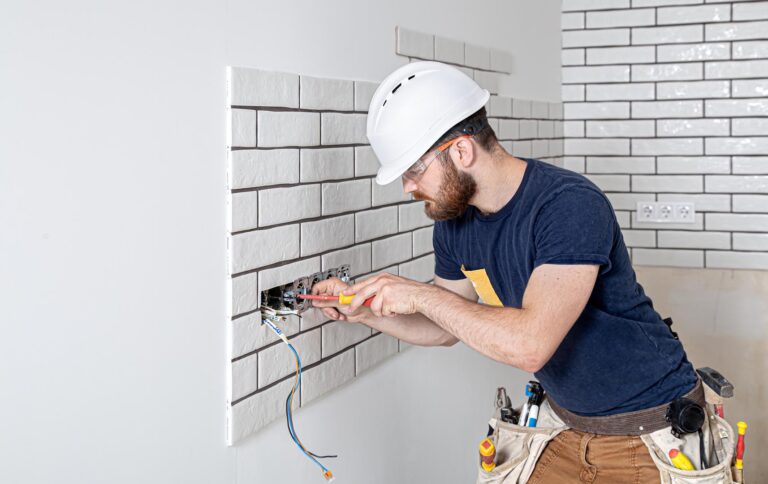 Electrician Builder At Work, Installation Of Sockets And Switche