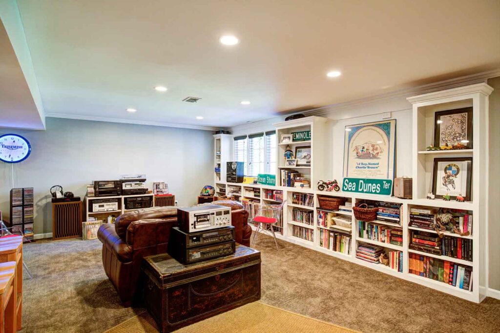 Basement lounge with built-in bookshelves and media space in Chevy Chase Lexington KY