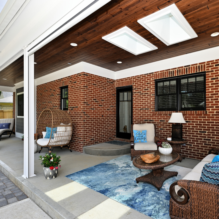 Covered patio with wicker furniture and skylights