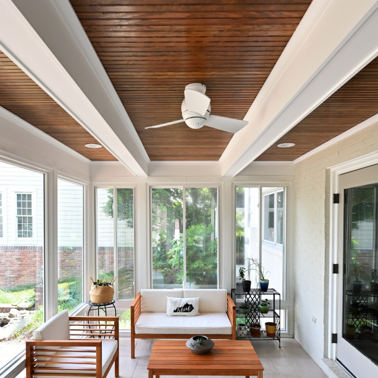 Newly constructed screened-in porch with comfortable seating and a ceiling fan attached to a Lexington home.