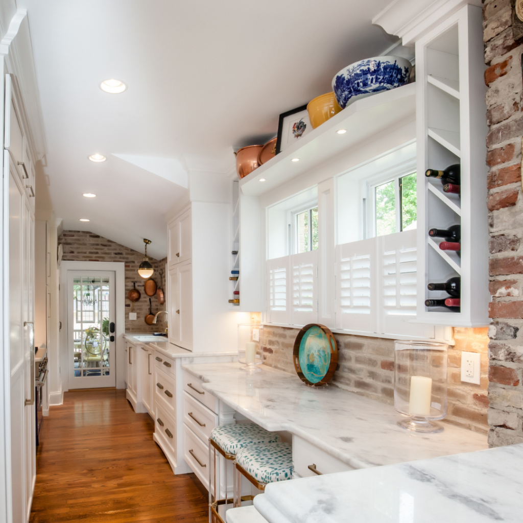 Small-scale kitchen remodel in the Chevy Chase neighborhood of Lexington KY with white cabinetry, marble countertops, brick backsplash, and natural light.